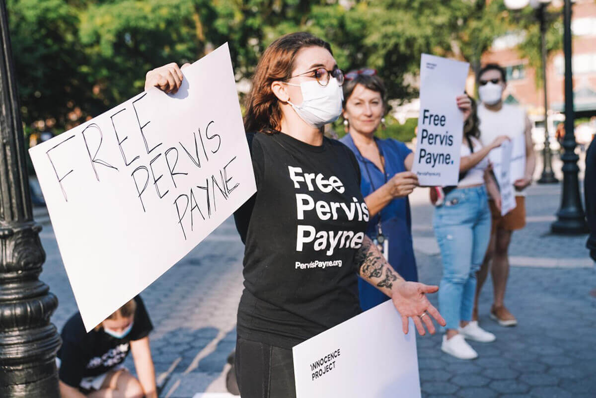 Woman holding 'Free Pervis Payne' sign